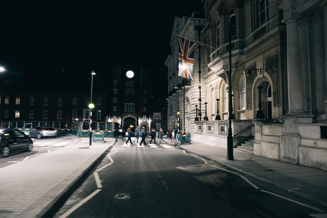 An empty city street under lamplight, long after dark