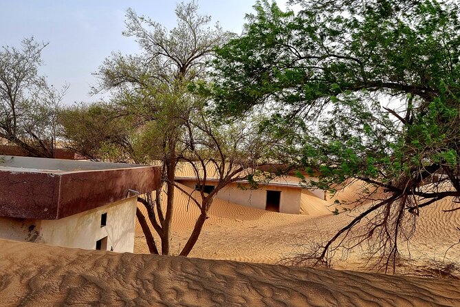 The Ghost Village Safari Tour with Dune Bashing and Sandboarding - Pickup, group size, and the pace of the day