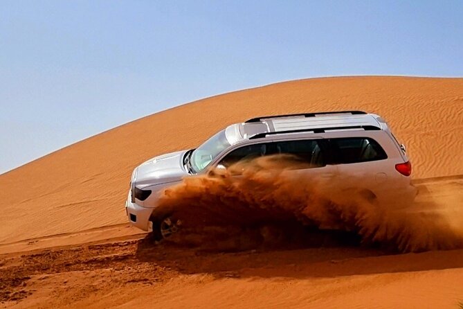 The Ghost Village Safari Tour with Dune Bashing and Sandboarding - Sandboarding on the red dunes
